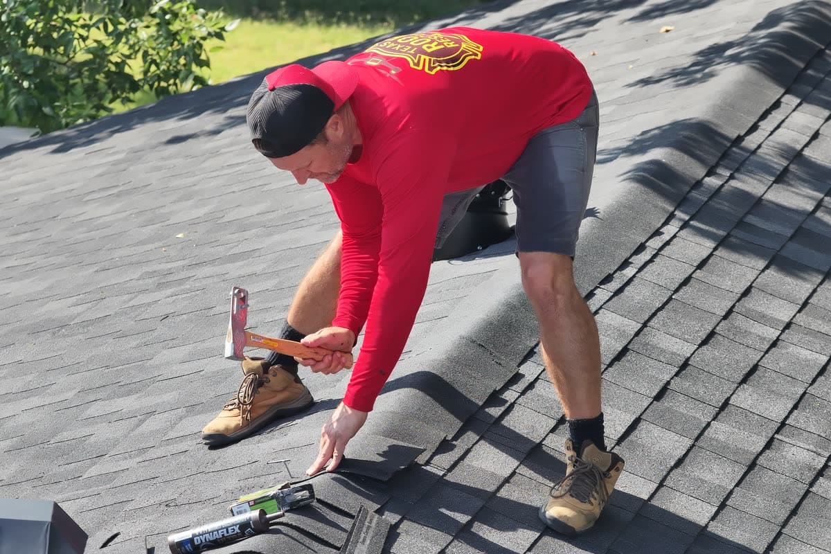 Shingle and flashing repair — sealing a lifted course by hand